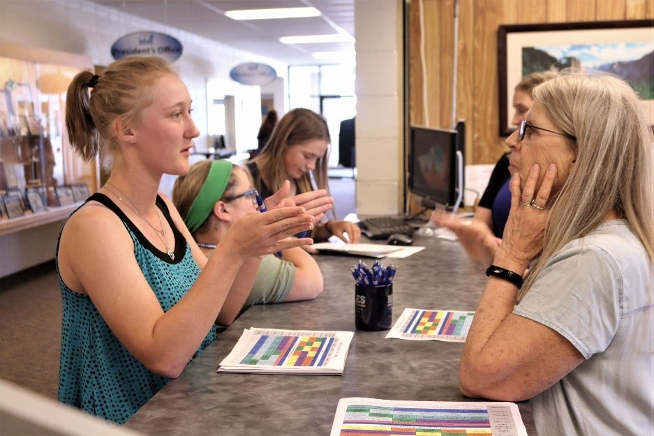 New MCC students visits with staff at the Student Services Desk on the MCC Campus