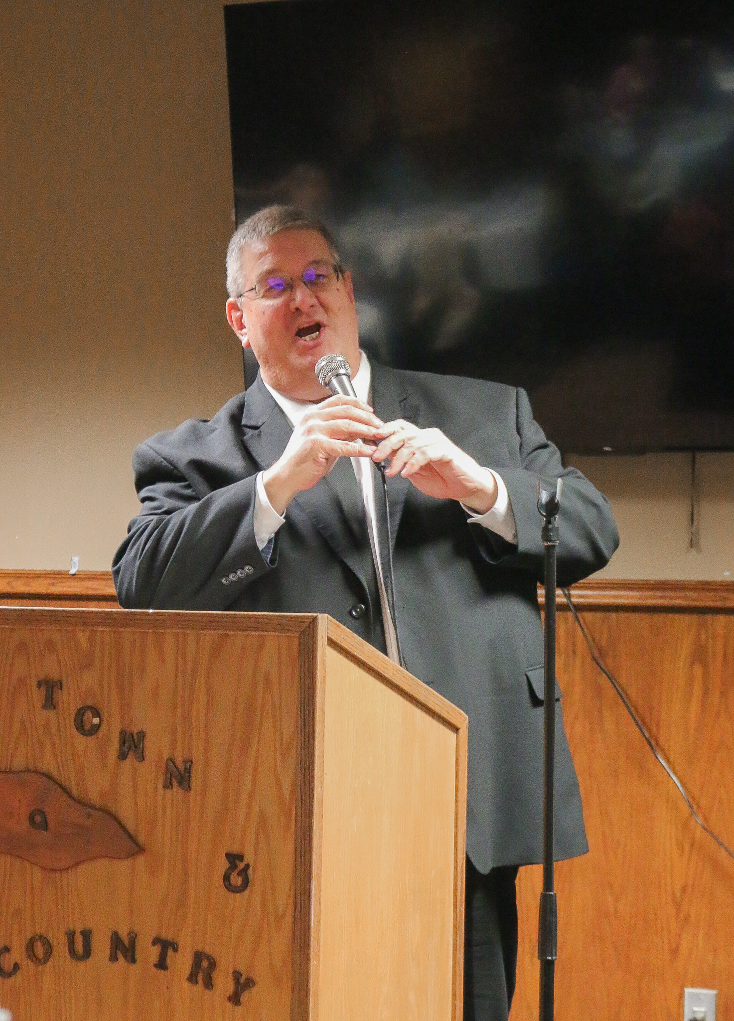 Adult male speaking at podium