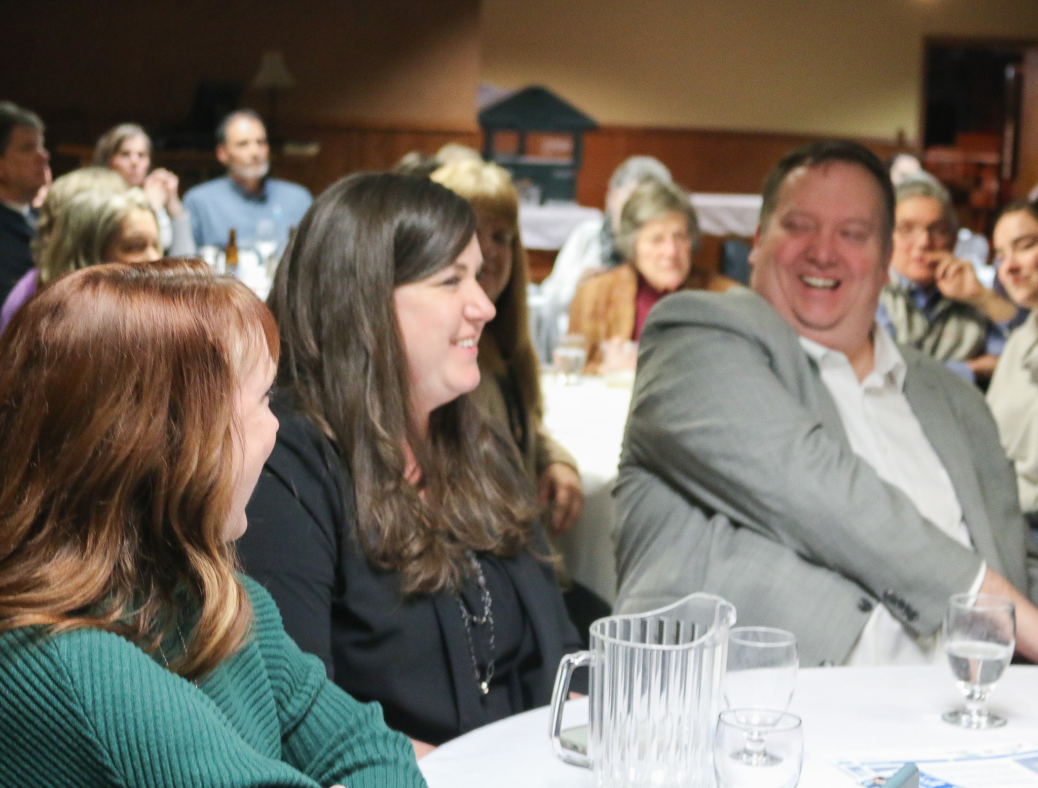 Three adults laughing