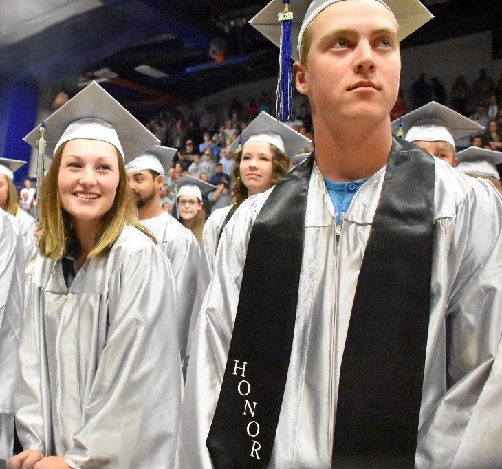 Image of two college students graduating