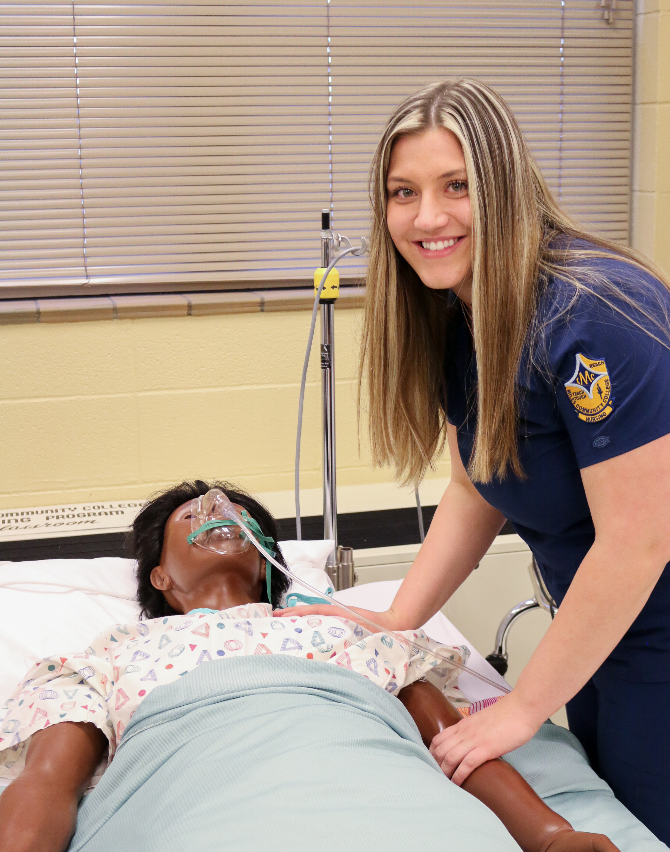Image of female nursing student with mannequin