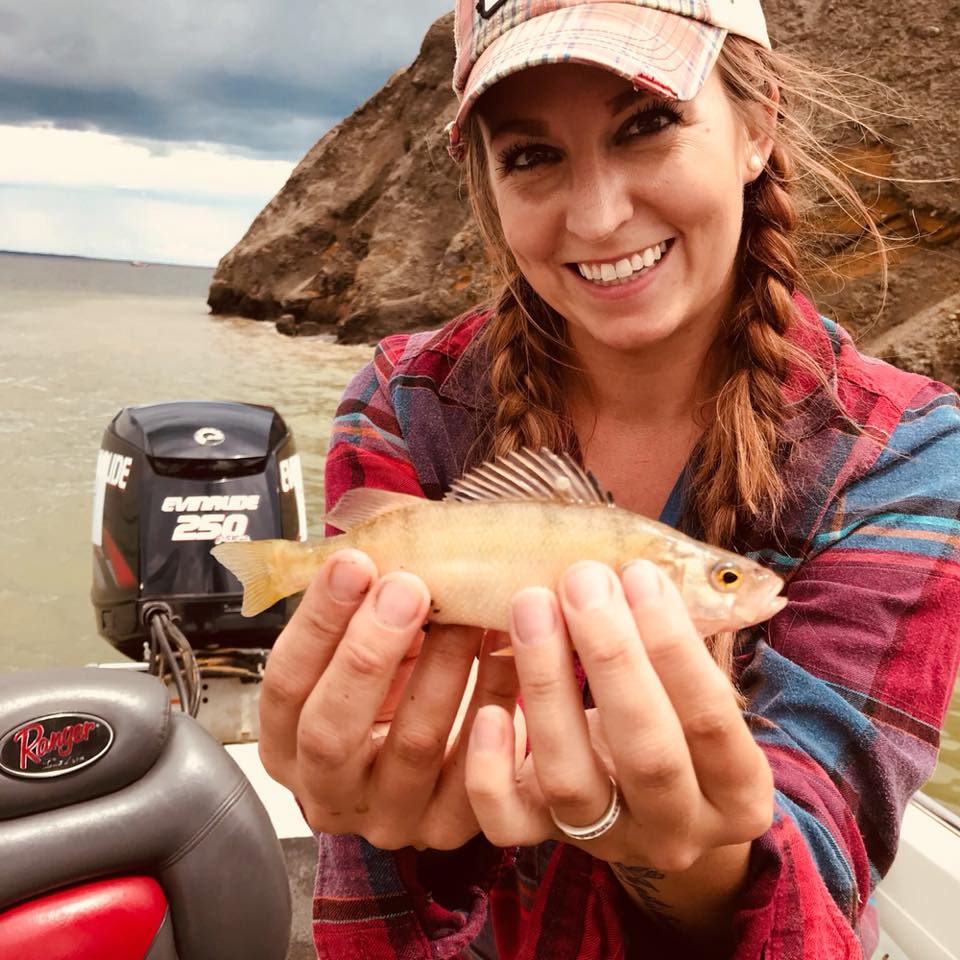 Adult smiling holding fish