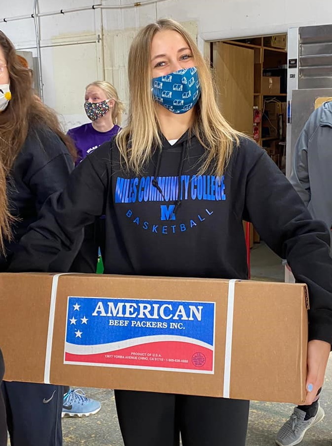 Womens Basket Ball team member helping at the local food bank 